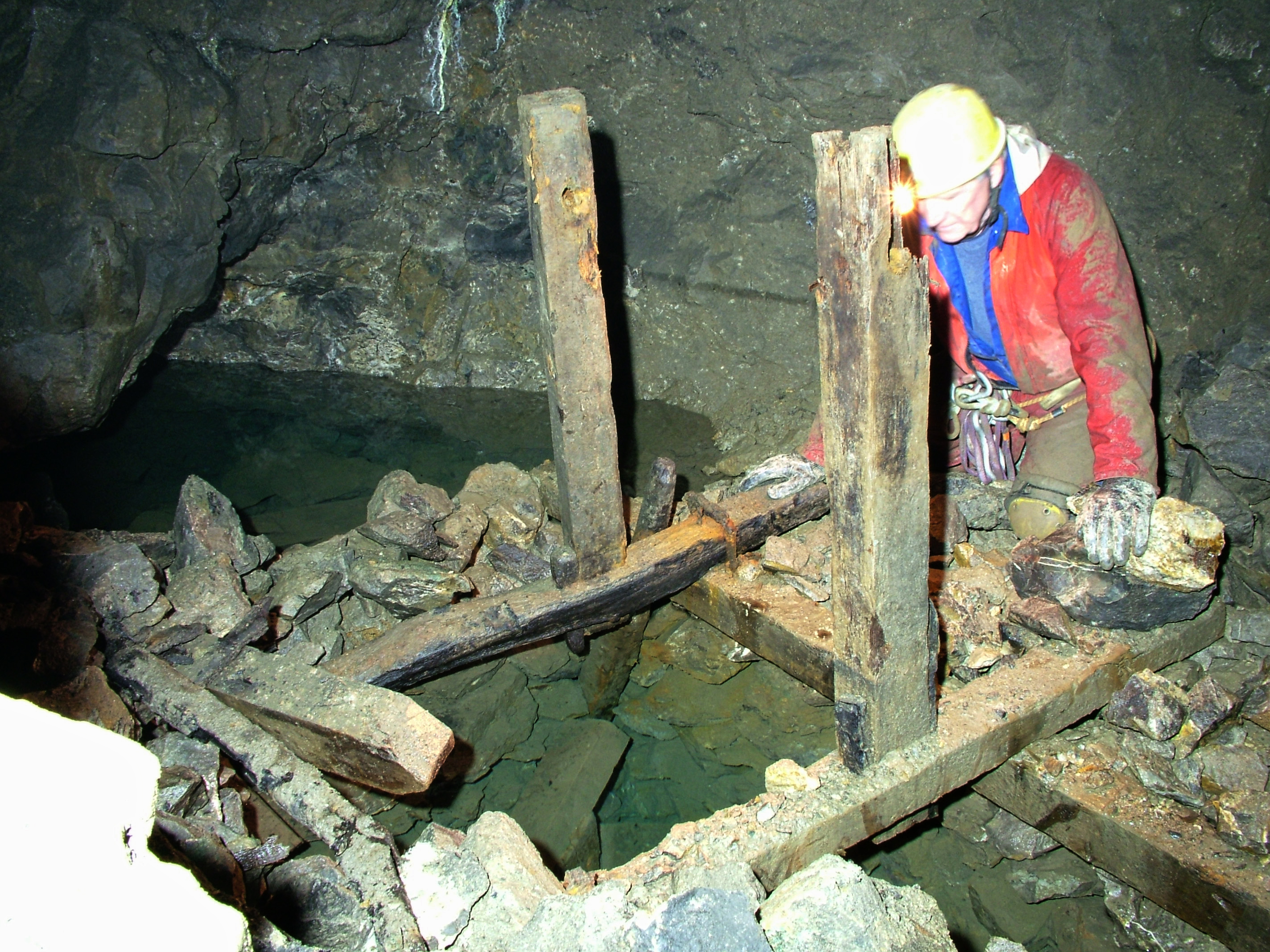 Brian Edwards looking into the depths at an old windlass frame